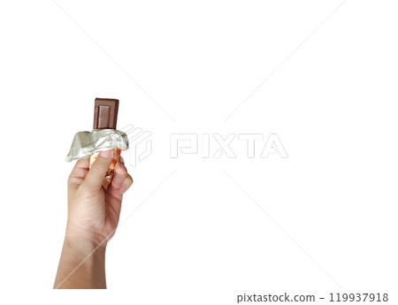 Hand holding brown chocolate bar on white background. Sweet treat in opened package. Hand holding brown chocolate bar on white background. Sweet treat in opened package. 119937918