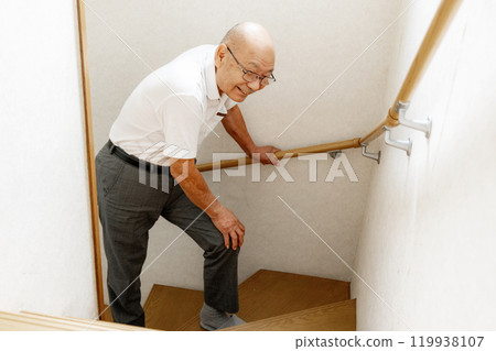 Senior man climbing stairs Senior man climbing stairs 119938107
