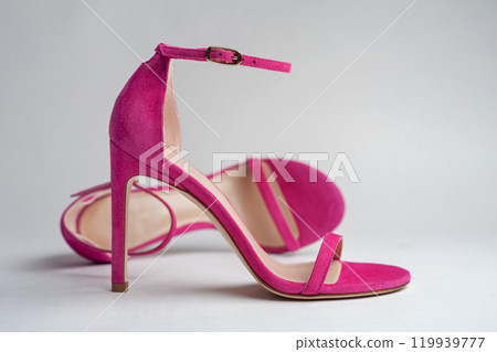 Woman's pink high heels shoes with ankle strap on a white background. Pink summer female sandals. 119939777