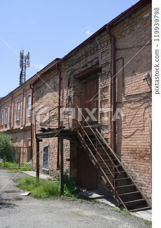 An old 19th century brick building with a cellular antenna on the roof in Kuibyshev, Russia An old 19th century brick building with a cellular antenna on the roof in Kuibyshev, Russia 119939798