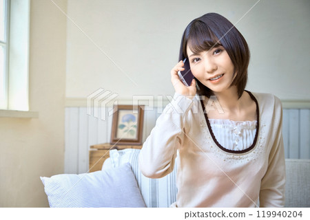 A woman talking on a smartphone 119940204