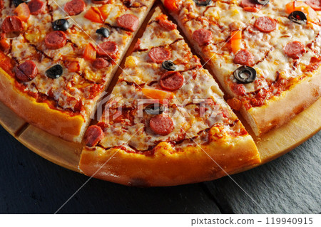 Delight in a mouthwatering pizza adorned with pepperoni slices and black olives, fresh tomato pieces, and a rich swirl of sauce, perfect for any occasion. Delight in a mouthwatering pizza adorned with pepperoni slices and black olives, fresh tomato pieces, and a rich swirl of sauce, perfect for any occasion. 119940915