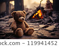 Resilience Amidst Ruin Old Teddy Bear Sits in the Remnants of a House, Symbolizing the Devastation After Conflict, War, Earthquake, or Natural Disaster. Conveying the Heartbreaking Concept of Child 119941452