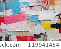 Urban Tapestry A Visual Symphony of Old Wrinkled Grunge Ripped Torn Placard Posters Background, Featuring Weathered Advertising Poster Pieces in White, Pink, Blue, and Yellow Colors on a Wall.. 119941454