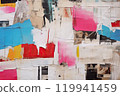 Urban Tapestry A Visual Symphony of Old Wrinkled Grunge Ripped Torn Placard Posters Background, Featuring Weathered Advertising Poster Pieces in White, Pink, Blue, and Yellow Colors on a Wall.. 119941459