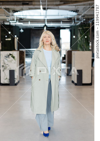 Confident Woman Walking in Modern Industrial Office Space Confident Woman Walking in Modern Industrial Office Space 119941787
