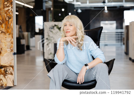 Confident Woman in Modern Office Setting Portrait Confident Woman in Modern Office Setting Portrait 119941792