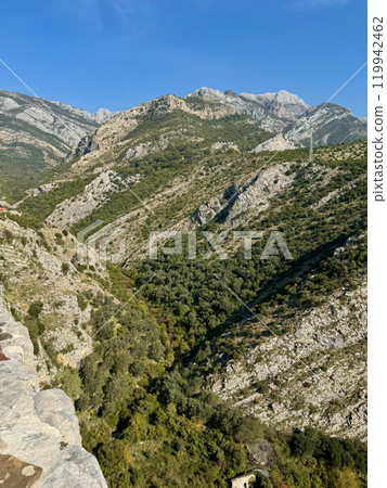 Autumn mountains in Montenegro, old city Bar, covered with vibrant green grass against a clear blue sky Autumn mountains in Montenegro, old city Bar, covered with vibrant green grass against a clear blue sky 119942462