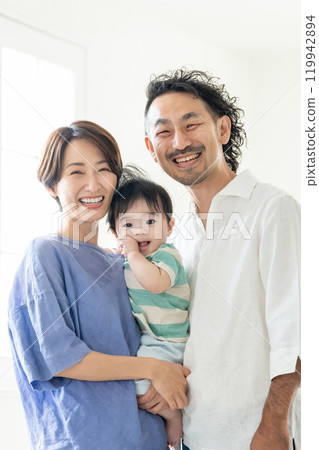 Middle-aged couple holding a baby 119942894
