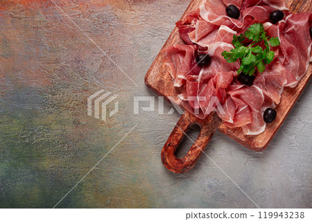 sliced prosciutto, on a cutting board, with olives and herbs, snack, breakfast, no people, sliced prosciutto, on a cutting board, with olives and herbs, snack, breakfast, no people, 119943238