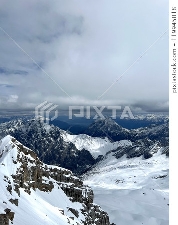 Snow-Covered Mountain Peaks Above the Clouds on Zugspitze Summit 119945018