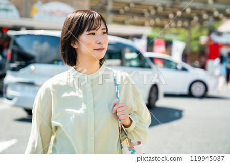 A woman stopping at a service area to take a break while driving A woman stopping at a service area to take a break while driving 119945087