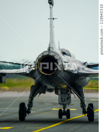 Swirling hot air behind the turbine exhaust of a working fighter jet, blurred photo Swirling hot air behind the turbine exhaust of a working fighter jet, blurred photo 119945310