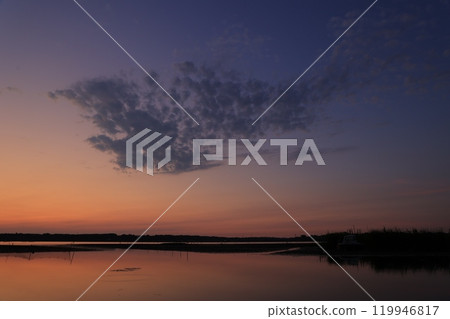 Morning glow reflected on the water surface Morning glow reflected on the water surface 119946817