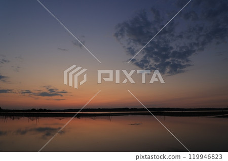 Morning glow reflected on the water surface Morning glow reflected on the water surface 119946823