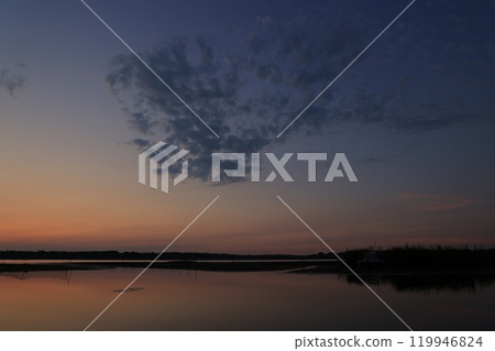 Morning glow reflected on the water surface Morning glow reflected on the water surface 119946824