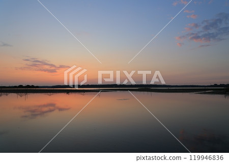 Morning glow reflected on the water surface Morning glow reflected on the water surface 119946836