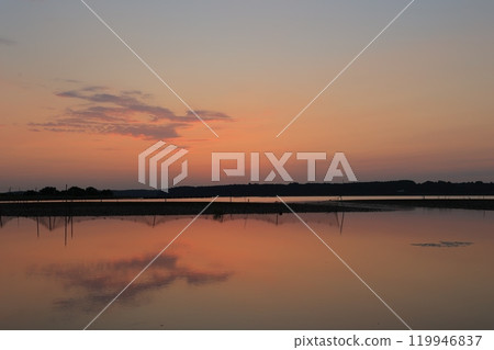 Morning glow reflected on the water surface Morning glow reflected on the water surface 119946837
