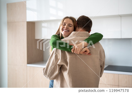Happy overjoyed woman hugging husband with closed eyes, feeling love, sincerity in relationship. Happy overjoyed woman hugging husband with closed eyes, feeling love, sincerity in relationship. 119947578
