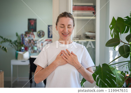 Happy in gratitude calm woman with closed eyes keep hands close to heart pray feeling thankful, hope Happy in gratitude calm woman with closed eyes keep hands close to heart pray feeling thankful, hope 119947631