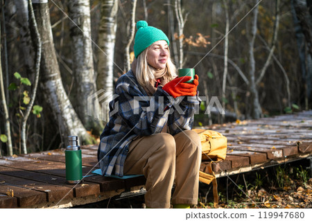Time alone. Relaxed middle aged woman enjoy calm weekend in fall park meditative drinks thermos tea. Time alone. Relaxed middle aged woman enjoy calm weekend in fall park meditative drinks thermos tea. 119947680