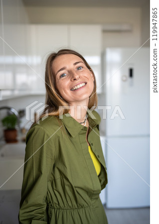 Portrait happy smiling blonde woman looking at camera standing at home having good mood enjoy time. Portrait happy smiling blonde woman looking at camera standing at home having good mood enjoy time. 119947865