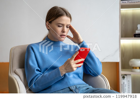 Busy concerned woman in smartphone, manage business correspondence from home. Headache and busy work Busy concerned woman in smartphone, manage business correspondence from home. Headache and busy work 119947918