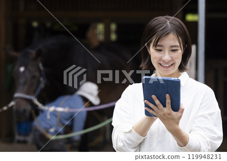 Woman taking care of a horse Woman taking care of a horse 119948231