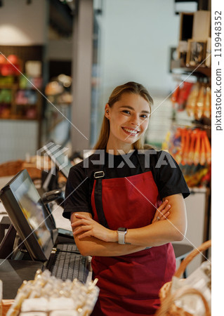 Cheerful Barista Smiling in a Cozy Caf Environment 119948352
