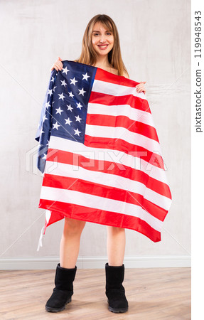 Young woman covering herself with USA flag 119948543