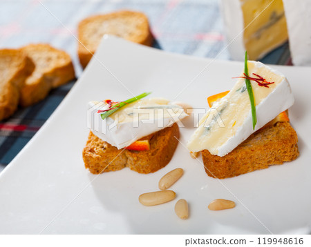 Canape with orange and blue cheese 119948616
