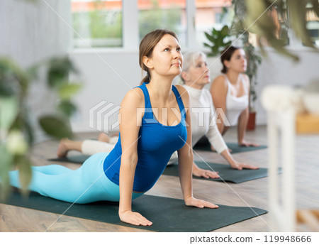 Sport women practice the cobra pose 119948666