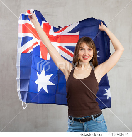 Happy woman posing with Australian flag in studio Happy woman posing with Australian flag in studio 119948695