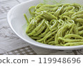 Close-up of Italian pasta with pesto sauce in a white bowl 119948696