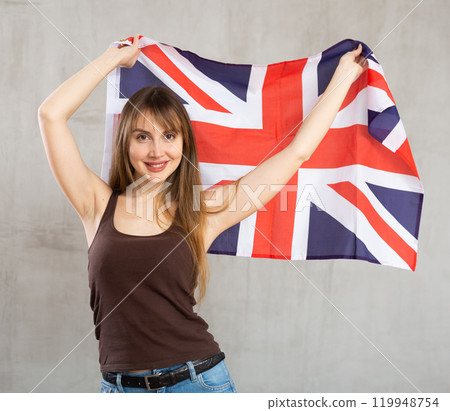 Young happy pretty woman displaying flag of united kingdom 119948754