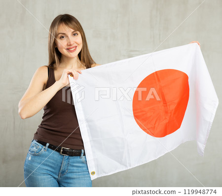 Young cheerful woman holding Japan flag 119948774