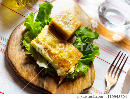 Flija - baked puff pastry with cream or cheese. Served on lettuce leaf. Albanian or Kosovo cuisine Flija - baked puff pastry with cream or cheese. Served on lettuce leaf. Albanian or Kosovo cuisine 119948804