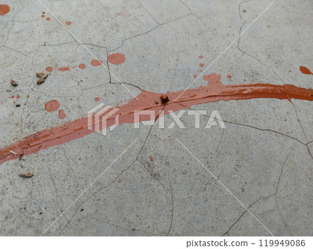 floor is stained with several drops of red color. Dripping paint on the concrete floor beautiful art. paint on concrete floor background 119949086