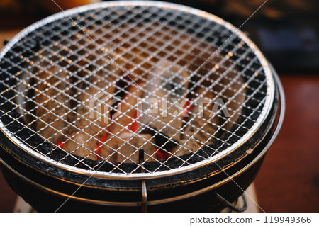Charcoal grill and burning charcoal 119949366