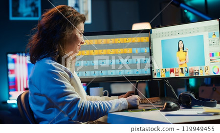 Photographer using software on computer to perform editing operations, enjoying cup of coffee while correcting images. Photo editor using PC to make adjustments to photographs in studio, camera A Photographer using software on computer to perform editing operations, enjoying cup of coffee while correcting images. Photo editor using PC to make adjustments to photographs in studio, camera A 119949455