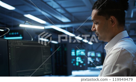 Computer scientist overseeing data center, making improvements and updates to ensure system can handle networking tasks. Close up of woman in server room tracking network traffic, camera B Computer scientist overseeing data center, making improvements and updates to ensure system can handle networking tasks. Close up of woman in server room tracking network traffic, camera B 119949479