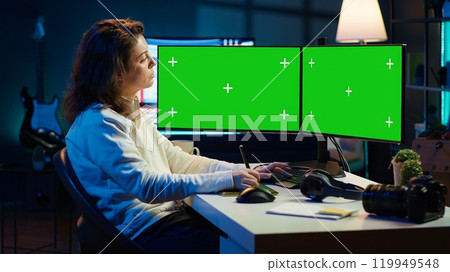 Content specialist uses graphic tablet to make social media post on isolated screen multi monitor setup for advertising company. Photo editor using mockup PC to create promotional image, camera A Content specialist uses graphic tablet to make social media post on isolated screen multi monitor setup for advertising company. Photo editor using mockup PC to create promotional image, camera A 119949548