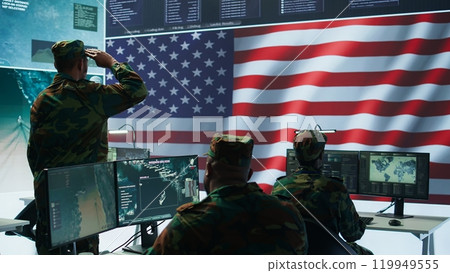IT analyst in a high tech base of operations handling surveillance activity and ensuring security protocols. Military command post crew collecting real time data to achieve objectives. Camera A. 119949555