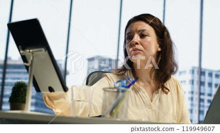 Professional goal oriented CEO analyzing global trends in high end office, planning the next steps for expansion and investment opportunities. Emphasizing executive power and work ethic. Camera A. Professional goal oriented CEO analyzing global trends in high end office, planning the next steps for expansion and investment opportunities. Emphasizing executive power and work ethic. Camera A. 119949607