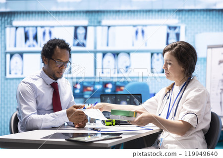 Woman physician offering drugs and painkillers on prescription medicine, recommending the right dosage and giving instructions to help relieve pain. Medicare insurance healthcare industry. 119949640