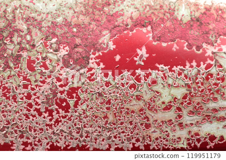 Texture or background of the metal wall is painted red with rust. and has corrosion, damage, chipping and peeling. 119951179