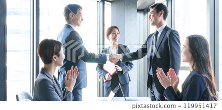 A businessman shaking hands in the office A businessman shaking hands in the office 119951417
