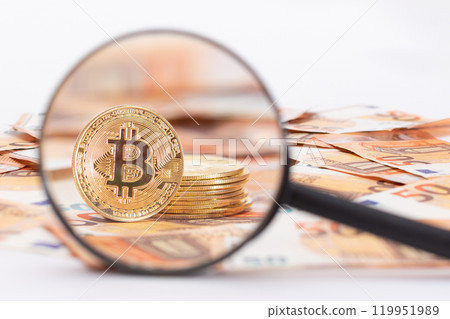 A Stack of Bitcoin Coins Visible Through a Magnifying Glass on the 50-Euro Banknotes A Stack of Bitcoin Coins Visible Through a Magnifying Glass on the 50-Euro Banknotes 119951989