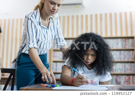 female teacher is teaching girls in class. School children education in classroom. kid schoolgirl happy learning. Writing as instructed by teacher. concept of back to school. female teacher is teaching girls in class. School children education in classroom. kid schoolgirl happy learning. Writing as instructed by teacher. concept of back to school. 119952127