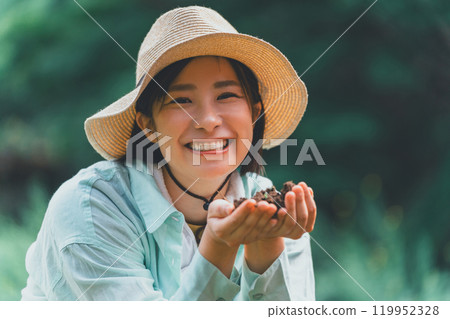 Young woman touching the soil Young woman touching the soil 119952328